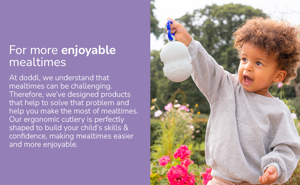 Image of toddler boy with curly hair showing off a doddl toddler cutlery travel case