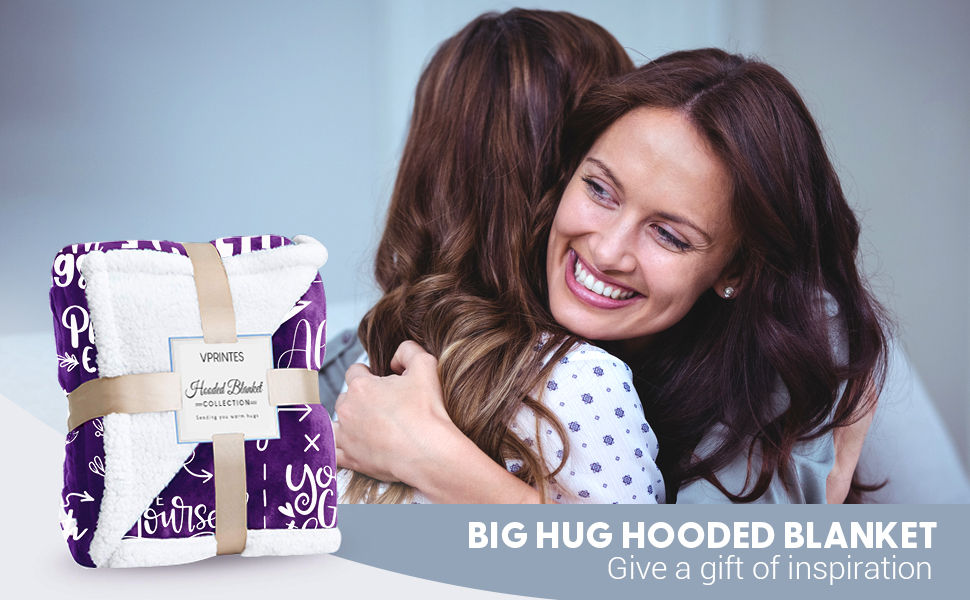 Two happy women hugging giving Vprintes hooded blanket as a gift