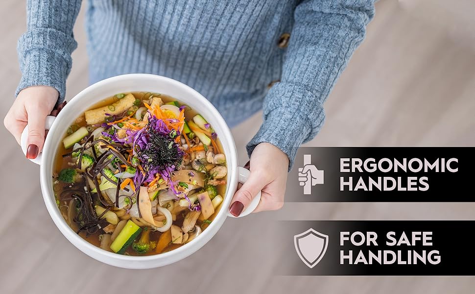 Woman is holding bowls of pho by the handles