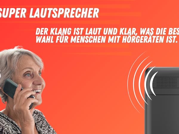 Handy mit großem Lautsprecher auf orangefarbenem Hintergrund, mit einfacher Tastatur und Display. Der deutsche Text weist auf verbesserte Klangfunktionen hin