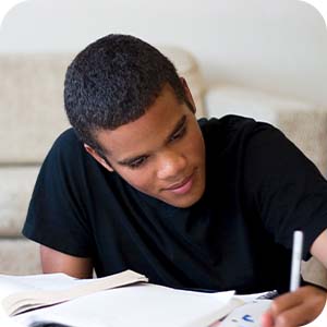 teen boy writing journal