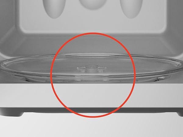 The inside of a small countertop microwave. Text reads: Glass turntable. 