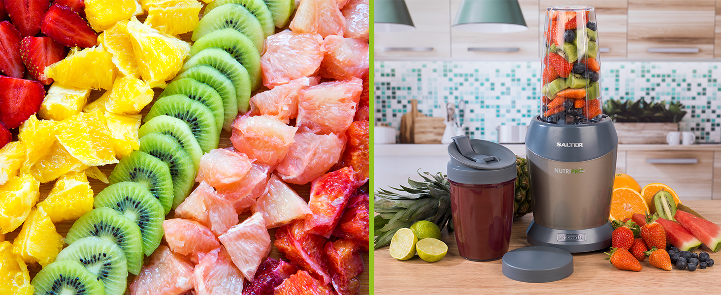 fresh healthy fruit smoothie and blender on kitchen worktop