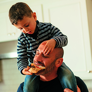 Dan's son feeds him pizza