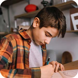 teen boy reading while eating breakfast