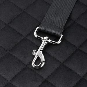 Metal swivel clip attachment with silver finish connected to black webbed strap, shown against quilted black fabric background.