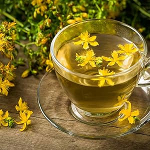 Image of yellow flowers floating in a glass water cup