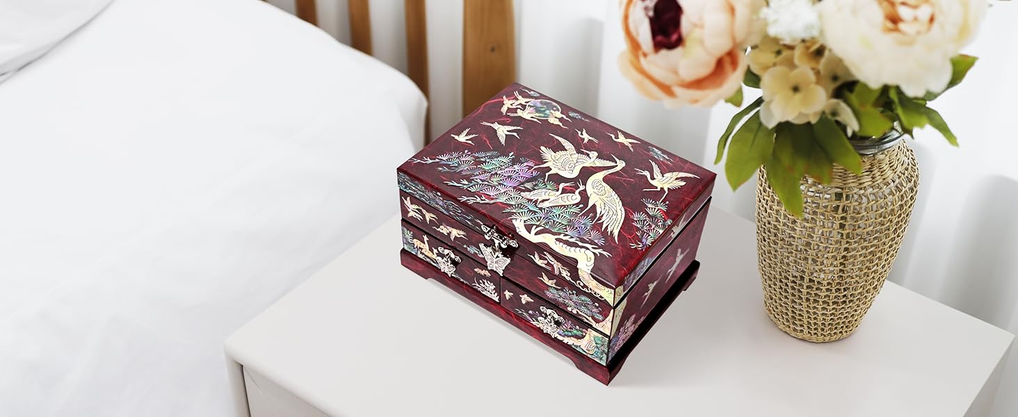 MADDesign Mother of Pearl jewelry box with drawers crane red on the bed side table