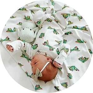 close up image of baby laying on blanket, both prints matching