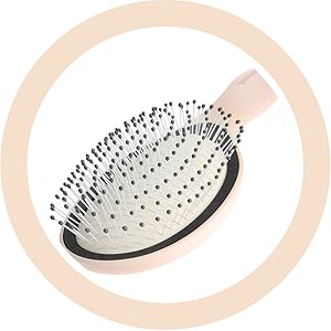 Brosse à cheveux de forme ovale à poils blancs et manche foncé, présentée dans un cadre circulaire