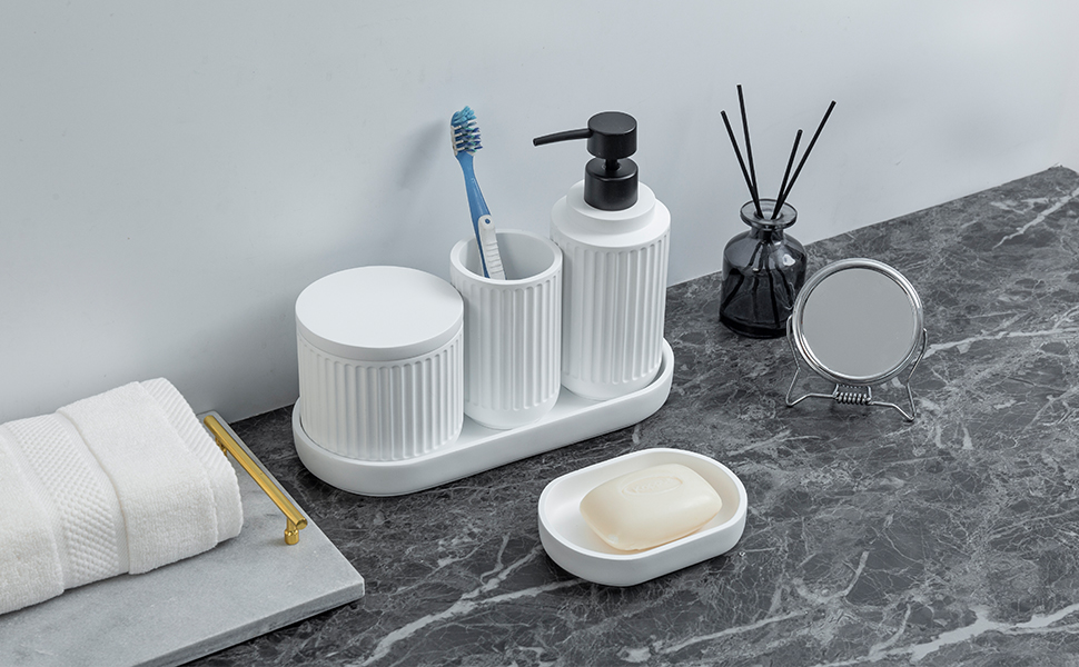 5 piece bathroom accessory set with white ceramic ribbed design on counter with tray and diffuser