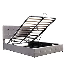 Gray upholstered bed frame with tufted headboard and lift-up storage mechanism, revealing slatted base underneath. Metal frame supports the lifting mechanism.