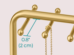 Close-up of a gold-colored metal stand with small spherical ends. A measurement of 0.8