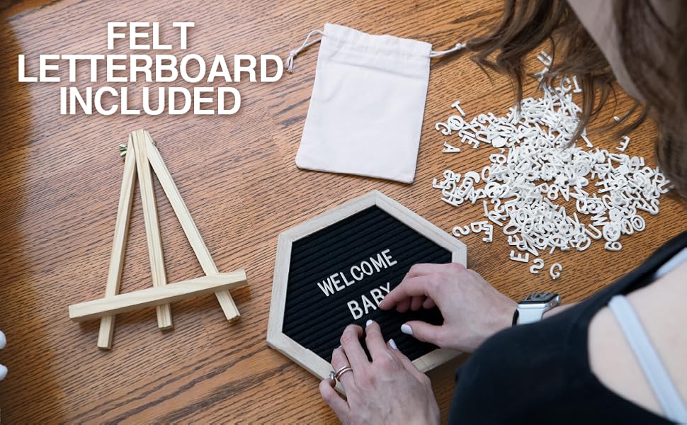 Mother using felt letter board to prepare for announcement of new baby