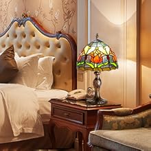 a bedroom with a bed, a chair, and a lamp.