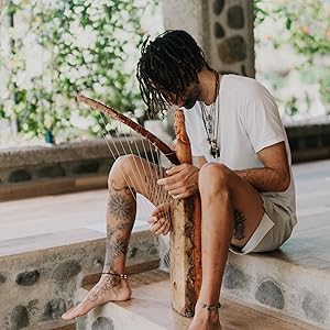 Troy Valencia playing the Bwiti African Ngombi (harp) instrument in Costa Rica