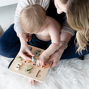 Mom and toddler playing with numbers toy during playtime