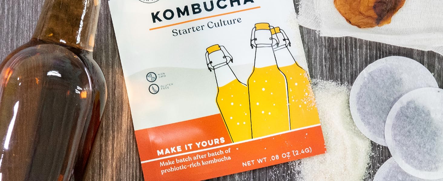 flatlay of kombucha starter culture with bottle, tea bags, sugar, and SCOBY; live kefir grains;