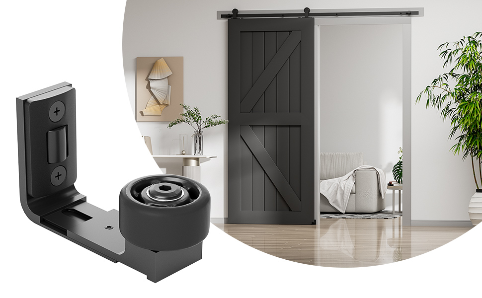 Barn door hardware with floor guide. Black metal bracket with wheel for sliding door, shown with rustic wooden door in bathroom setting.