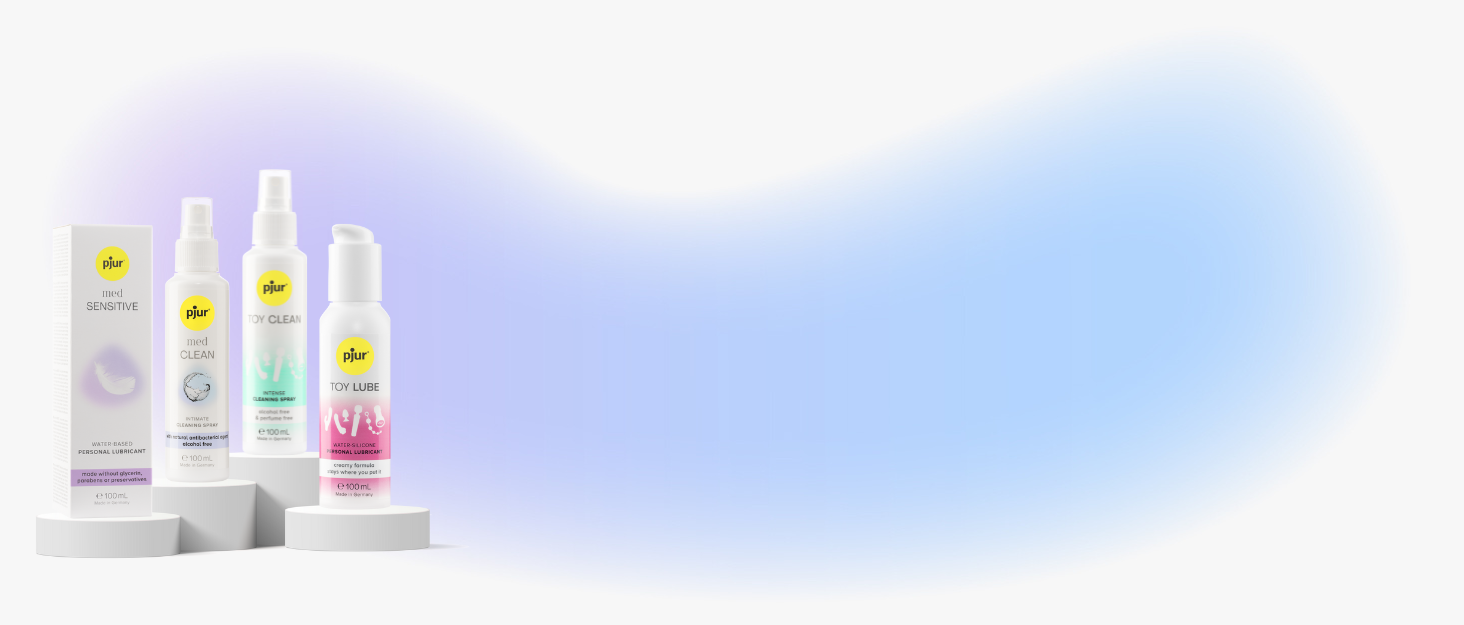 Product display of four skincare bottles in pastel colors arranged against a light background.