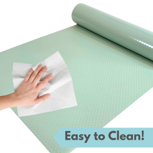 Turquoise reptile tank liner material being wiped with a paper towel