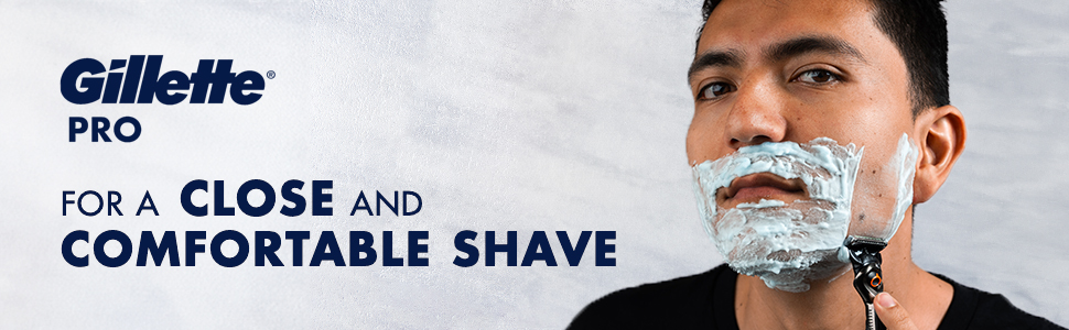 Content man is shaving w Proglide razor,using Pro Sensitive Shave Gel for close and comfortable
