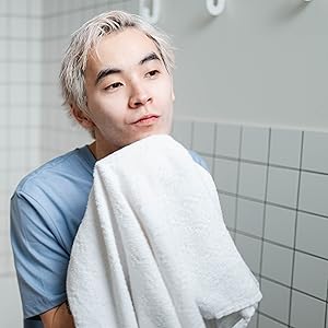 man with towel in bathroom for skincare