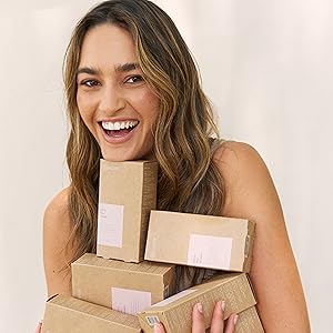 Model holding boxes of Daily Hair Vitamin