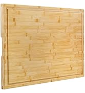 Large rectangular bamboo cutting board with juice groove. Smooth surface features natural wood grain pattern. Thick, sturdy construction with raised edges for stability and liquid containment.