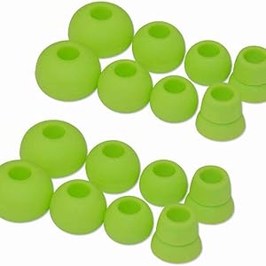 Multiple bright green silicone earbud tips in various sizes. The tips have a dome shape with a circular opening and are arranged in two rows.