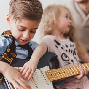 children with their father's guitar