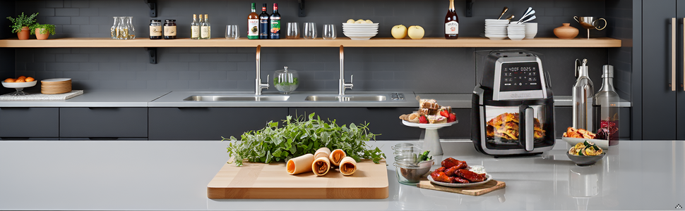 A kitchen counter with the product surrounded by fresh ingredients like potatoes, carrots, and herbs