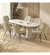Modern oval dining table with white marble top and pedestal base, surrounded by six cream-colored upholstered chairs with vertical channel stitching and black metal legs.