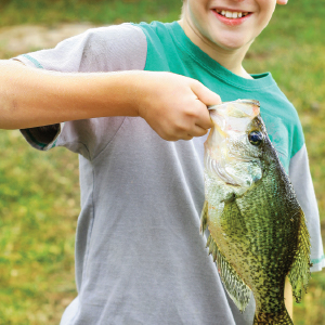 boy holding large game fish
