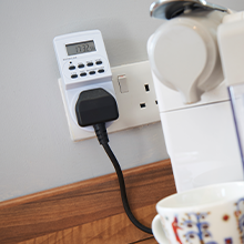 a coffee maker plugged into a wall outlet