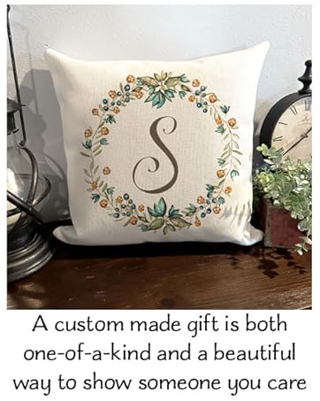 monogram pillow with flower wreath on a tablee