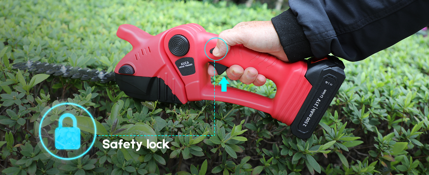 Red electric pruning shears held in use over plants. Features visible safety lock indicator and black battery pack. Hand grips ergonomic handle while demonstrating cutting action.