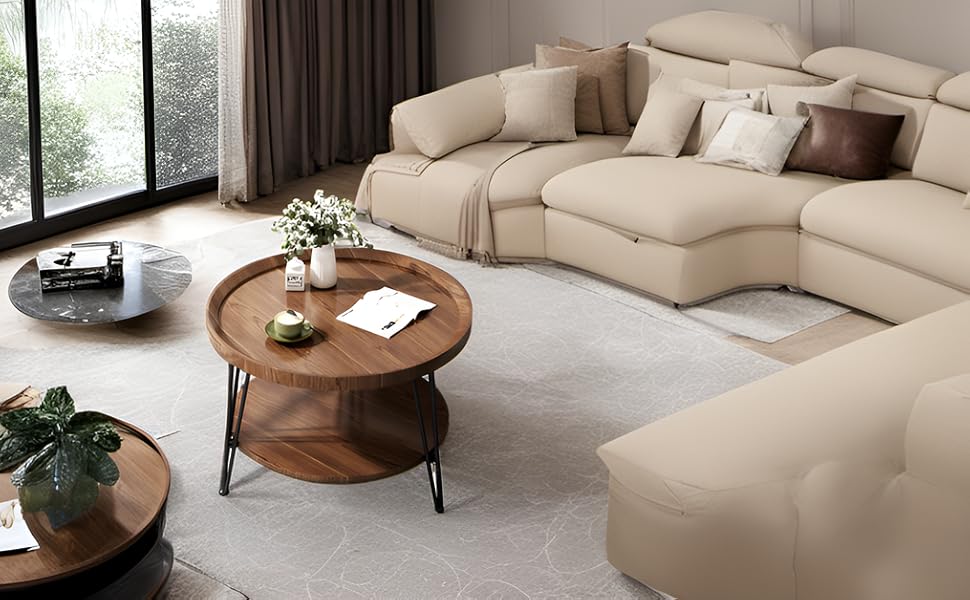 Large beige sectional sofa in a modern living room. Features chaise lounge, multiple sections, and decorative pillows. Round wooden coffee table nearby.