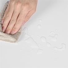 a person cleaning a towel with water droplets