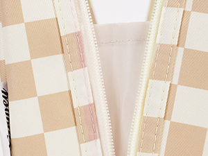 Close-up of a cream and tan checkered fabric pattern, likely from a garment or textile product.