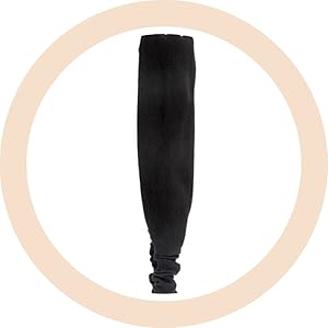 Couvre-bras ou manche noir présenté dans un cadre circulaire sur fond beige clair.