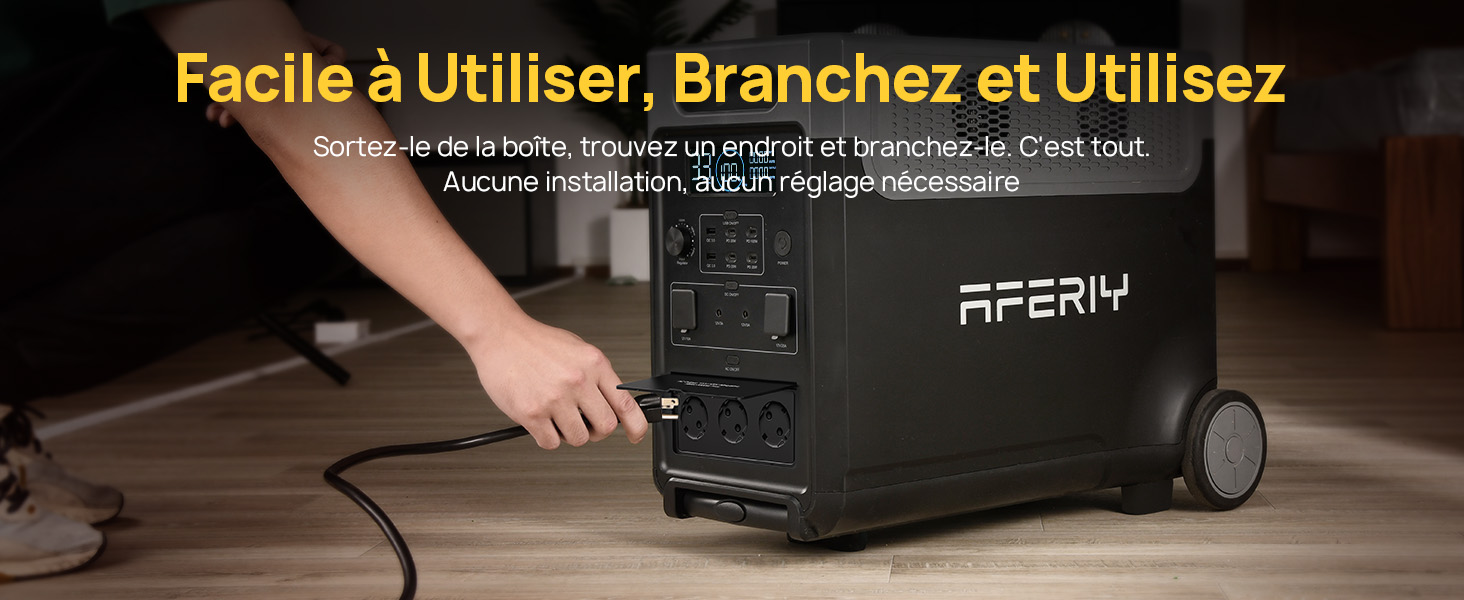 une personne utilise un câble d'alimentation pour connecter un ordinateur.