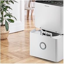 a white refrigerator freezer sitting on a wooden floor.