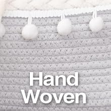 gray baby changing basket showing hand woven rope and pom poms