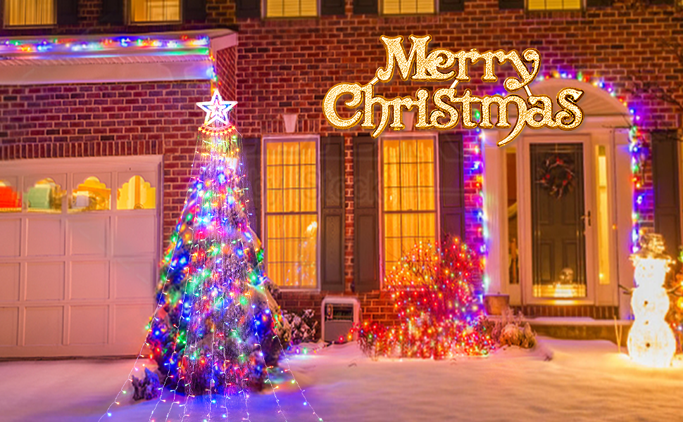 House exterior decorated for Christmas with colorful lights, illuminated tree, and 'Merry Christmas' sign. Brick facade, garage, and snowman figure visible.