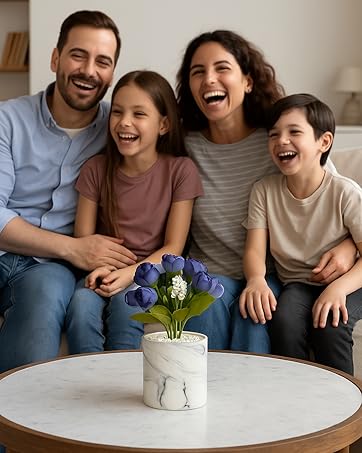 A family sitting on a sofa with a mini artificial indoor planter placed on the center table