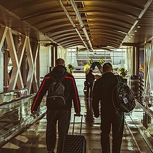 a group of people walking down a walkway.