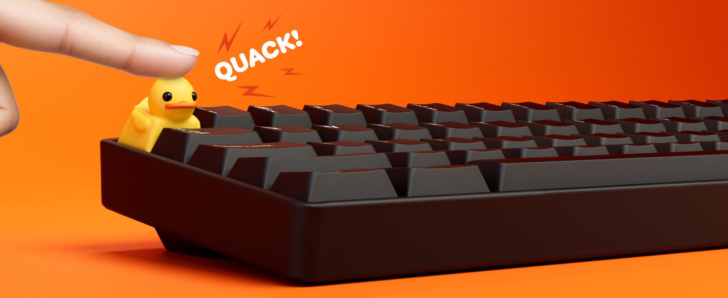 Finger pressing Duckey on the corner of the keyboard with text that spells out QUACK
