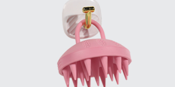 pink shampoo brush with adhesive