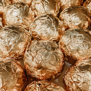 Hot cocoa bombs wrapped in gold foil